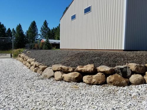 Boulder Retaining Wall to define landscaping and traffic areas