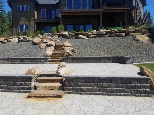 Boulder and concrete retaining wall with steps.