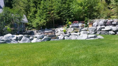 Boulder Retaining Wall with multiple levels and patio areas.