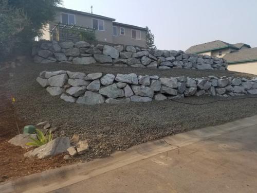 Boulder Retaining Wall to shore up land and create garden space.